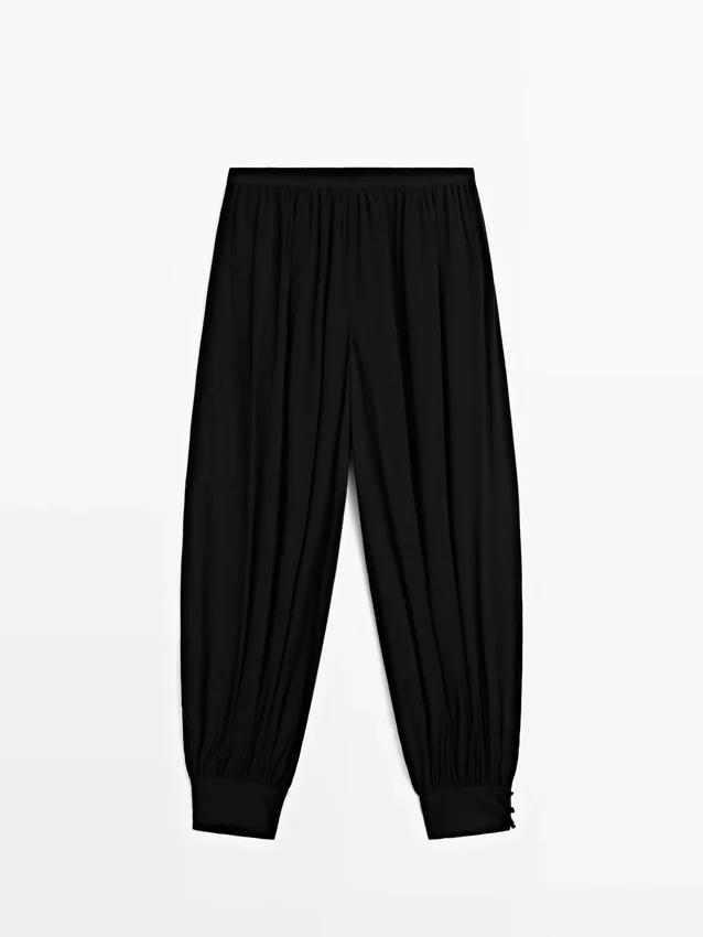 Halvtransparenta sarouelbyxor med knappdetaljer Halvtransparenta sarouelbyxor med knappdetaljer