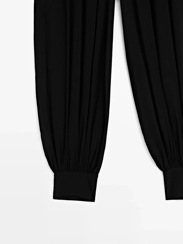 Halvtransparenta sarouelbyxor med knappdetaljer Halvtransparenta sarouelbyxor med knappdetaljer